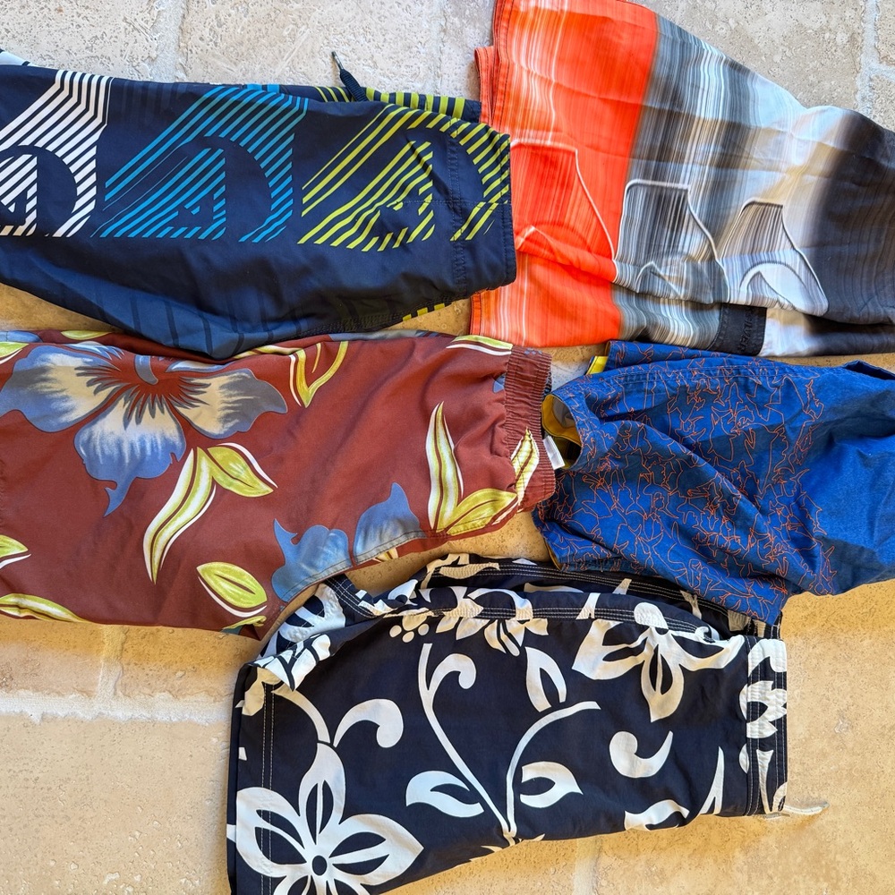 Two pairs of quicksilver Kids Swim Trunks plus more. NWOT rash guard